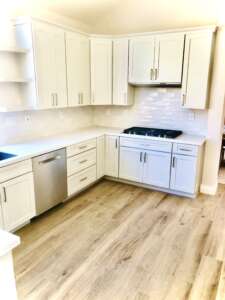 Kitchen with wooden flooring & white cabinet